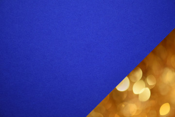 Closeup textured blue paper with Christmas yellow bokeh corner. Macro. Mock-up.