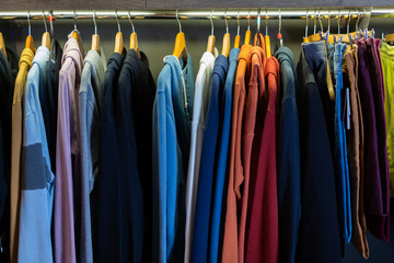 Different assortment of colorful clothing in boutique