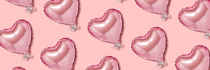 Pink air balloon in the shape of a heart on a pink background. Pattern. Love concept, valentines day. Banner. Flat lay, top view