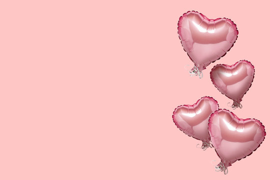 Flying pink air balloon in the shape of a heart on a pink background. Love concept, valentines day. Banner. Flat lay, top view