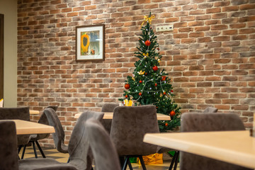 Christmas tree inside restaurant in front ow the wall