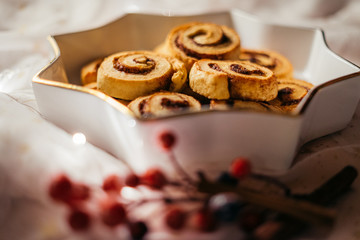  Christmas cinnamon stars on a beautiful plate with decoration and beautiful light - food photography