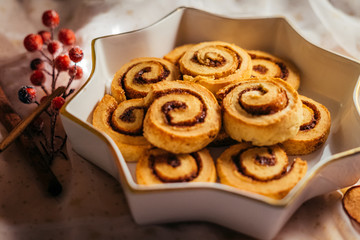  Christmas cinnamon stars on a beautiful plate with decoration and beautiful light - food photography