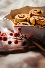  Christmas cinnamon stars on a beautiful plate with decoration and beautiful light - food photography