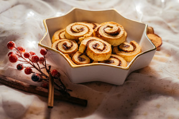  Christmas cinnamon stars on a beautiful plate with decoration and beautiful light - food photography