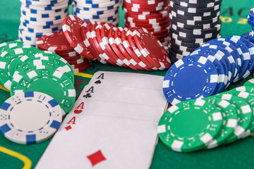 Fototapeta premium Gambling concept. Four aces combination with poker chips on green table