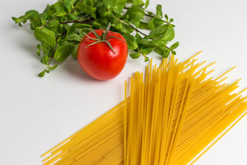 Durum wheat pasta on a white background. Tomatoes and mint