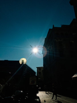 The sun shining on a clear blue sky in winter. Christmas decorations in the Padua, Italy
