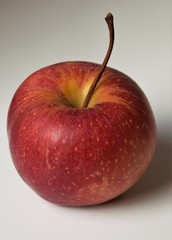 Single red juicy ripe apple closeup