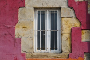 window on the red facade of the house in Bilbao Spain