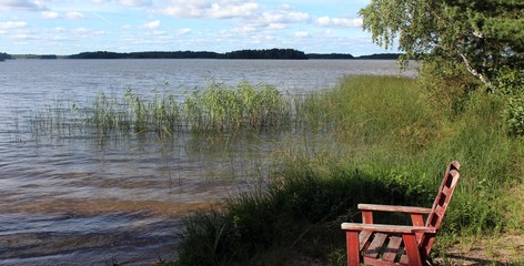 old single wooden chair on the beach