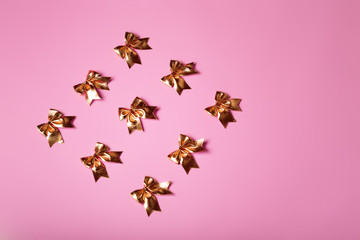 Pink celebration background with golden bows