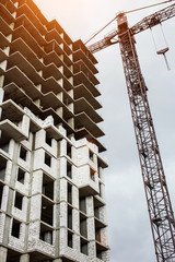 Construction site background. Hoisting cranes and new multi-storey buildings. I.ndustrial...