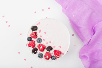 Breakfast smoothie bowl with yogurt, fresh raspberries, blueberries, BlackBerry, coconut flakes and granola. Healthy food. 