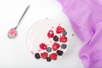 Breakfast smoothie bowl with yogurt, fresh raspberries, blueberries, BlackBerry, coconut flakes and granola. Healthy food. 