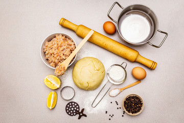 Fish dumplings. Ingredients for home cooking. Fresh dough, fish, spices, cooking equipment. Stone concrete background