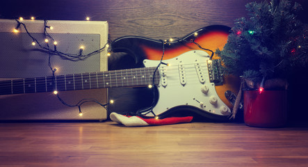 Old vintage electric guitar with Christmas lights