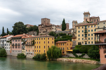 Fototapeta na wymiar Colorful Houses and Brenta river in Bassano del Grappa. Italy