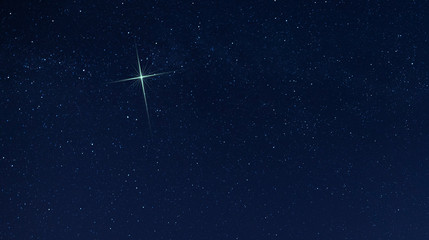 Obraz na płótnie Canvas Single star shining brightest in the night sky for the Christmas celebration