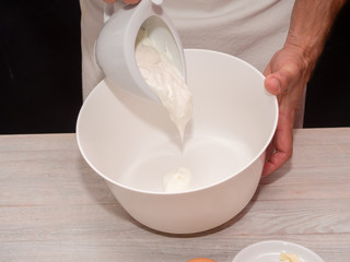 Adding Yogurt into bowl. Making Yogurt Cake.