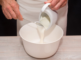 Adding Yogurt into bowl. Making Yogurt Cake.