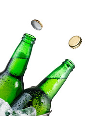 Two opened green beer bottles in bucket with flying caps, close up - 308426075