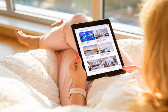 Riga, Latvia - July 21, 2018: Woman Looking At Airbnb Website On IPad.