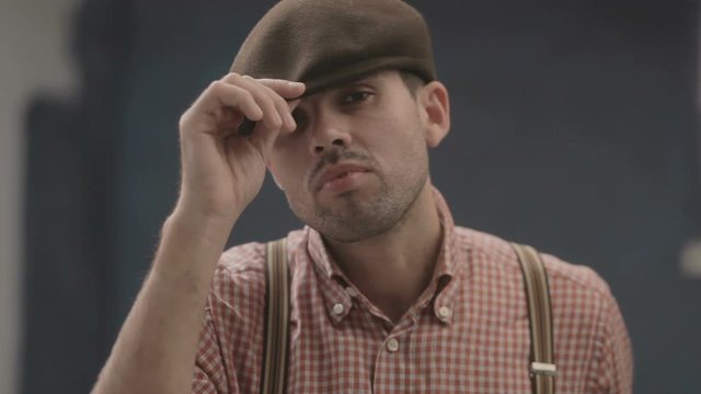 guy in a shirt with suspenders and cap