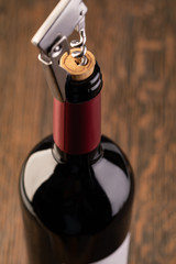 Corkscrew and bottle of wine