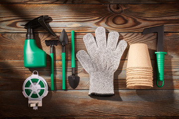 Gardening tools on wooden background flat lay