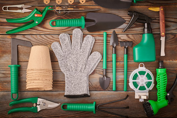 Gardening tools on wooden background flat lay