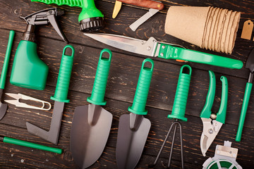 Gardening tools on wooden background flat lay