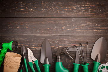 Gardening tools on wooden background flat lay