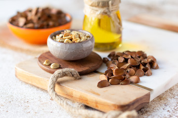 Beechnuts in shell, peeled and beech nut oil. Healthy organic food concept, vegetarianism