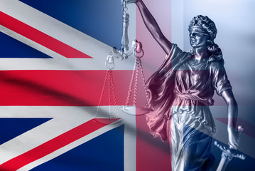 Statue of Justice over a British Union Jack flag