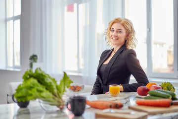 young business woman. a vegan breakfast with vitamins in the early morning in a vegan kitchen in a...