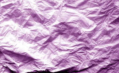 Fototapeta premium Crumpled sheet of paper with blur effect in purple tone.