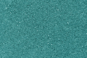 Weathered cement wall texture in cyan color.