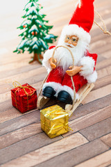 Santa Claus figurine christmas decoration over wooden background