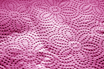 Paper towel surface with blur effect in pink tone.