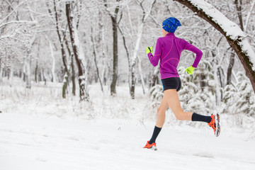 Fototapeta na wymiar girl running in winter snow scenery