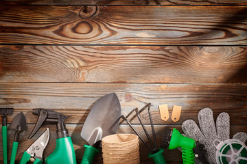 Gardening tools on wooden background flat lay