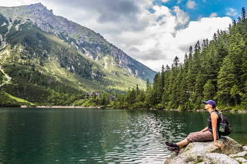 Fototapeta na wymiar Woman tourist with backpack at Morskie Oko lake near Zakopane, Tatra Mountains, Poland
