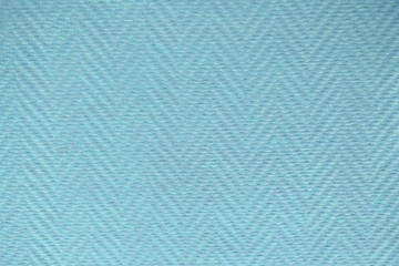 Blue paint texture on the wall with lines shaped herringbone pattern, background