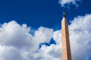 Ancient Lateran Obelisk among clouds, built during Pharaoh Thutmose III reign (15th century BC) and...