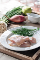 Sliced Herring Fish Fillet on White Plate. Dill and Onion