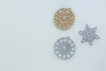 Christmas composition. Christmas wooden decorations painted gold and silver in color on a light background.