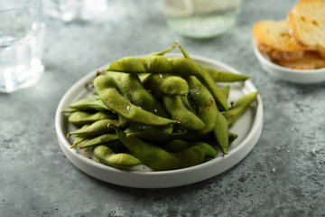 Edamame beans on a white plate