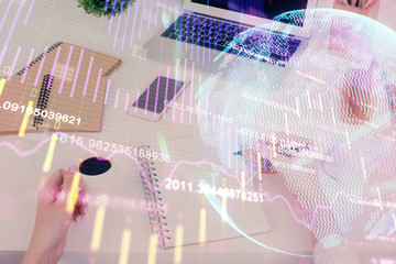 Hands writing information about stock market in notepad. Forex chart holograms in front. Concept of research. Multi exposure