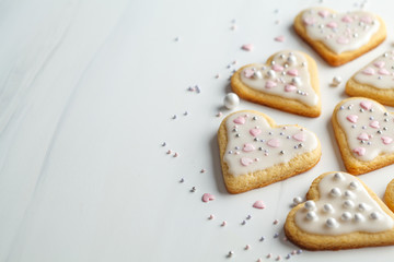 Cookies hearts with icing and decorated for Valentine's Day, white background, copy space. Valentine's day concept.